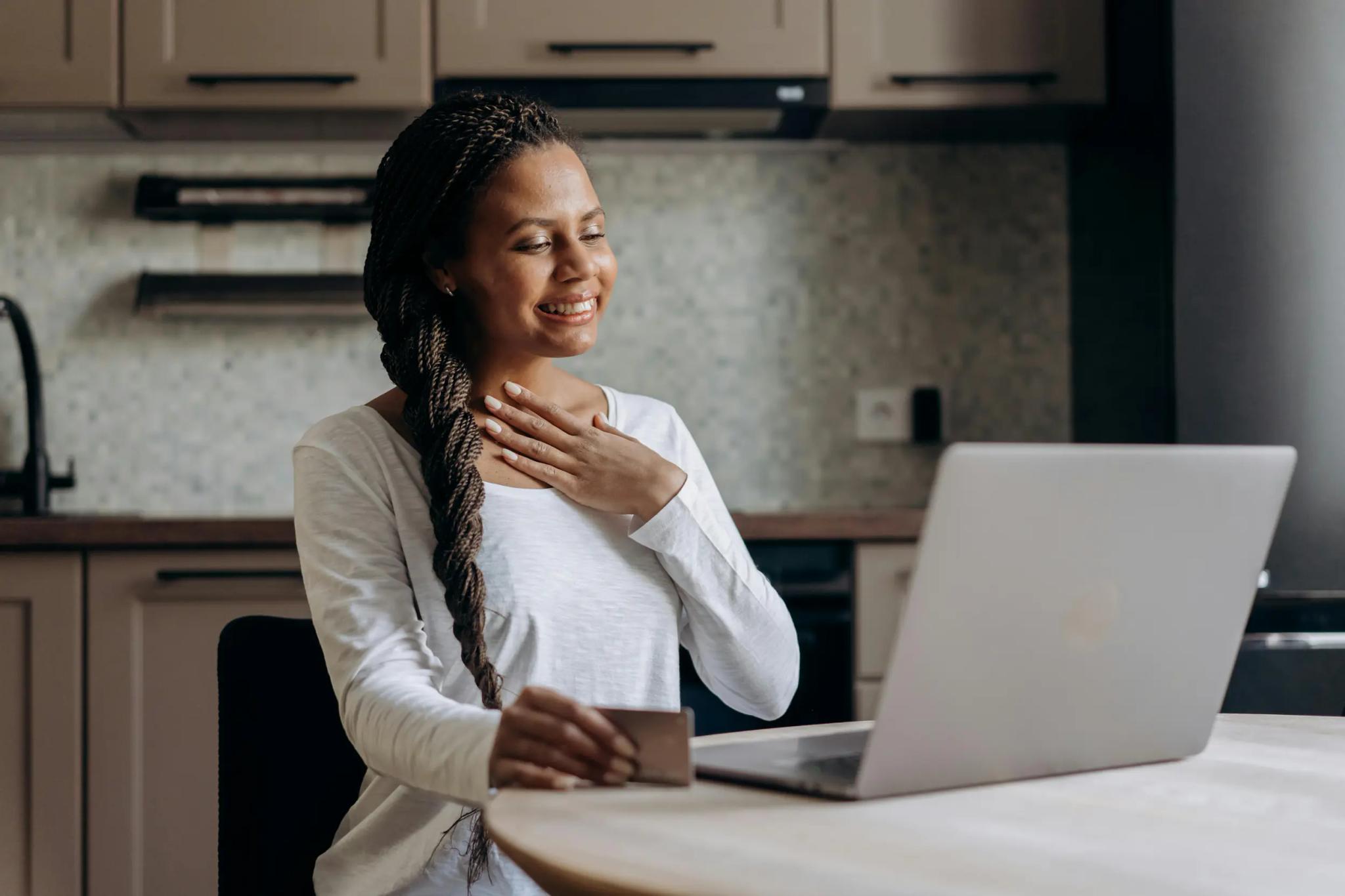 Woman doing online shopping with laptop and credit card