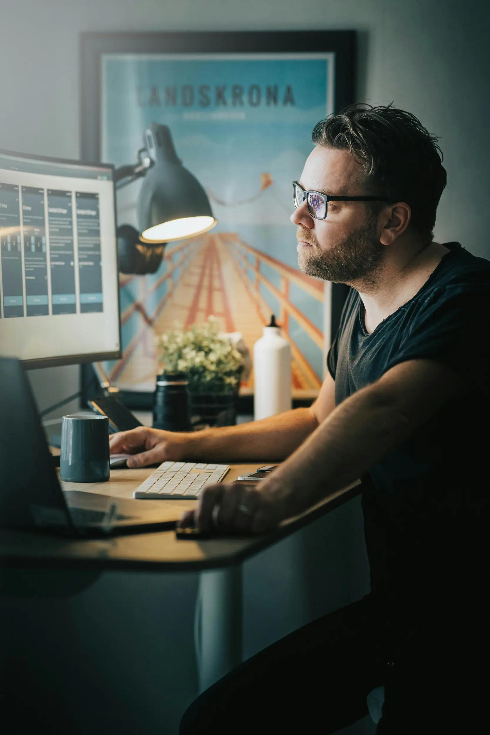 Man working at a computer desk in an office.