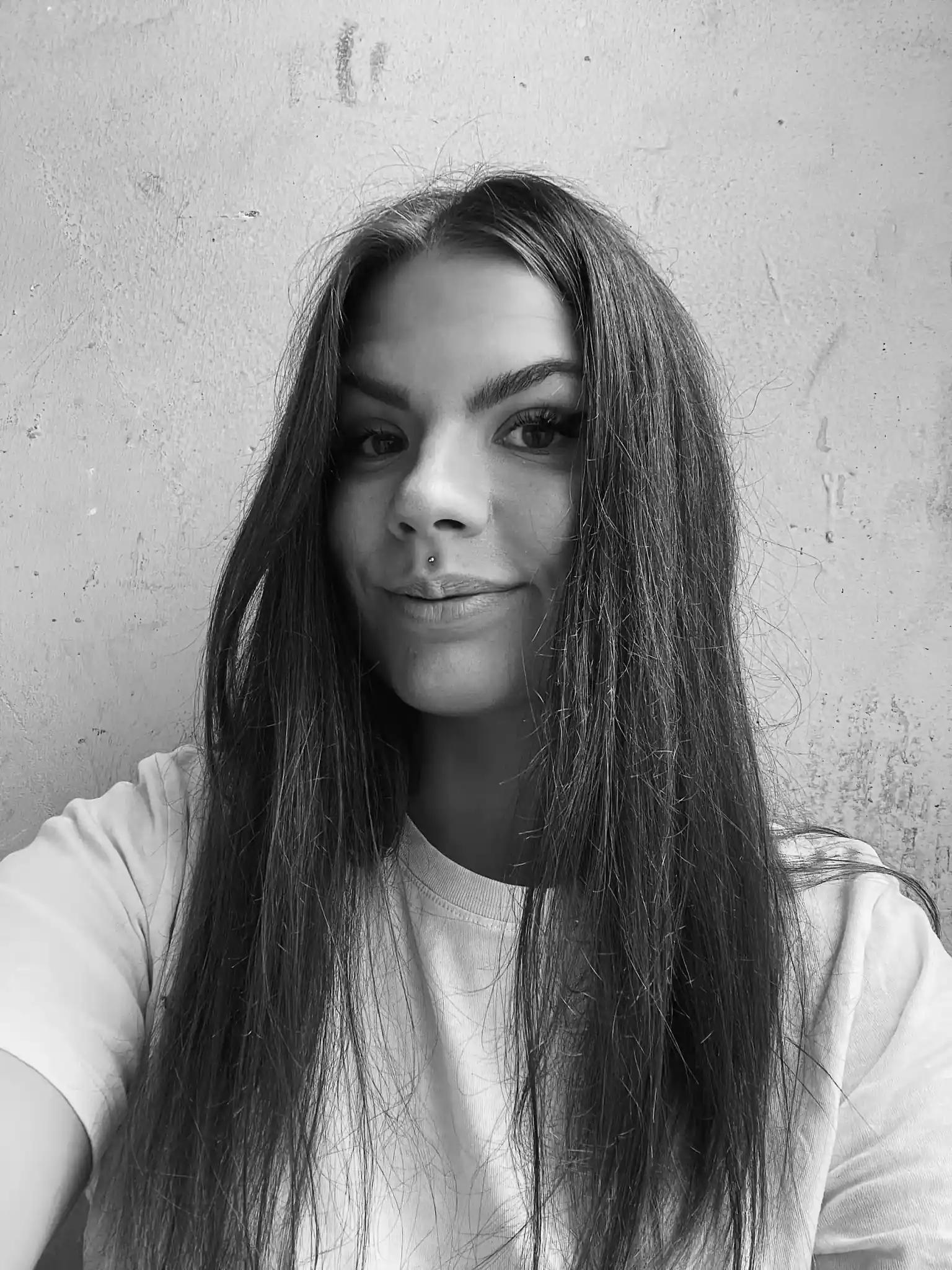 Black and white portrait of a young woman with long hair.