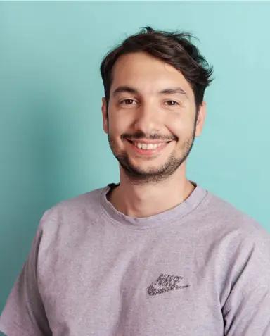 Portrait of a smiling man against a blue background