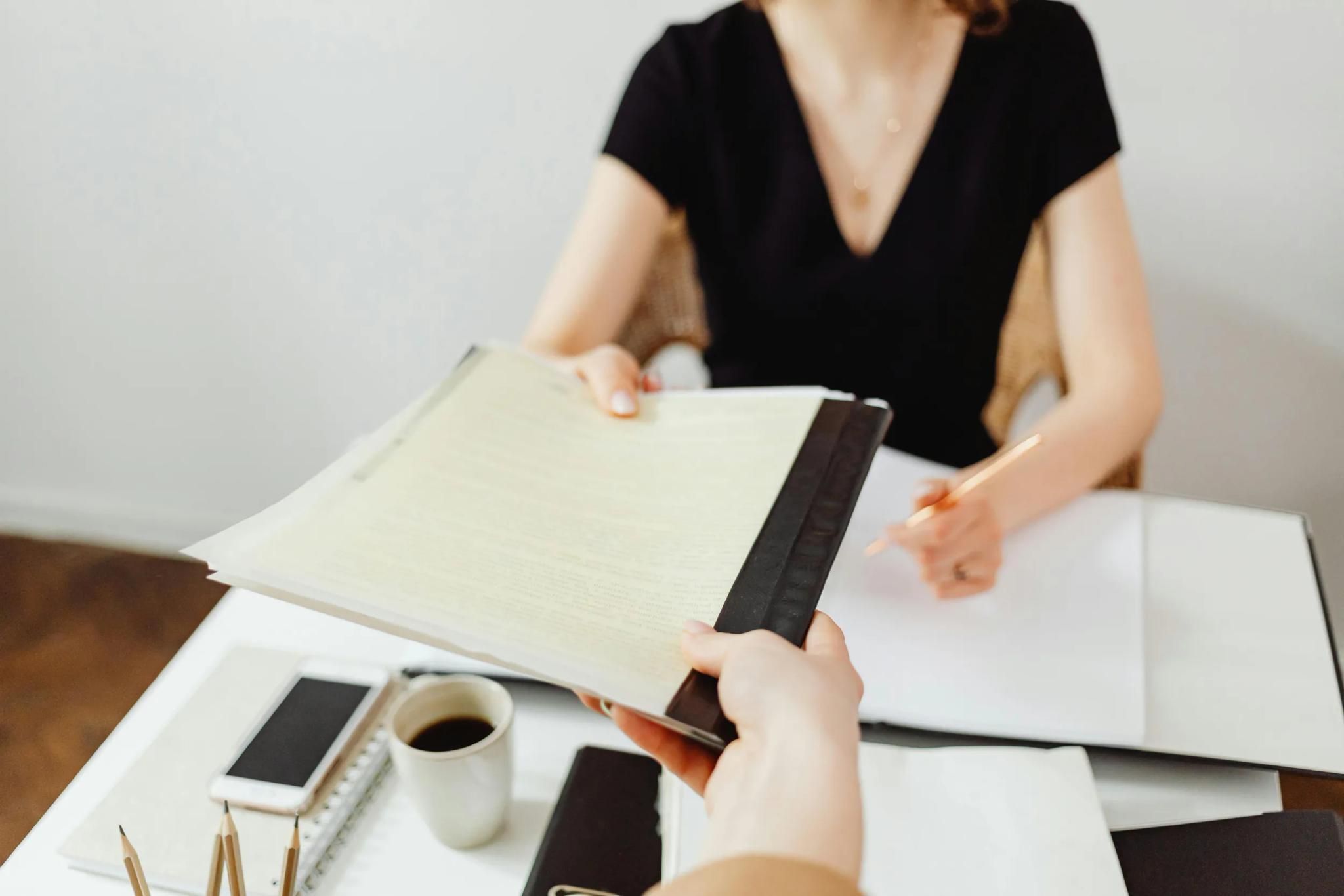 Handing over a document during a meeting