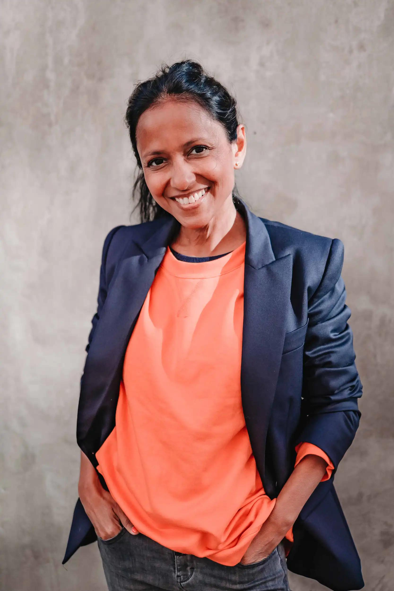 Woman smiling against gray background