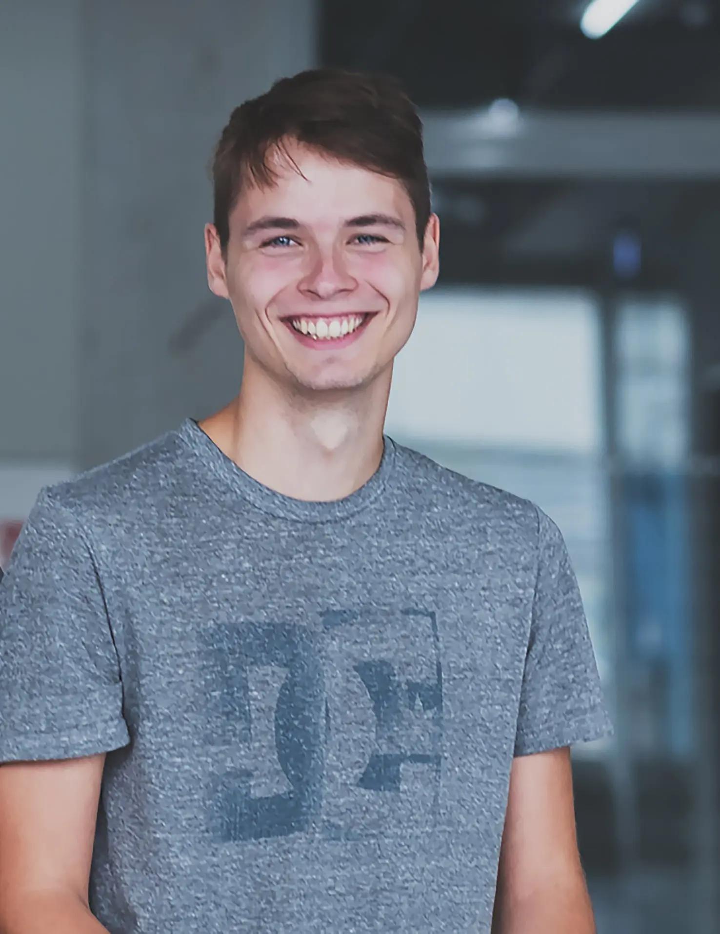 Smiling young man in gray t-shirt