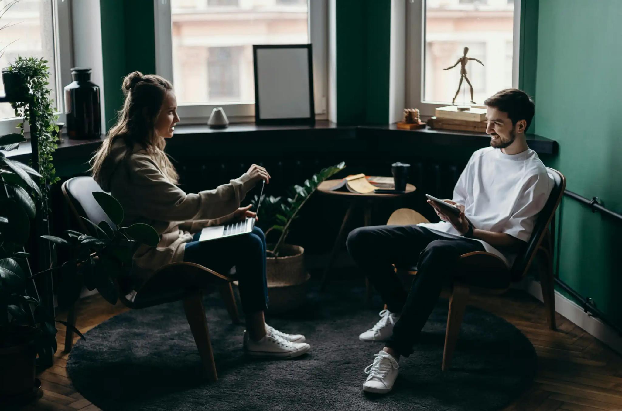 Two people having a conversation in a cozy room.