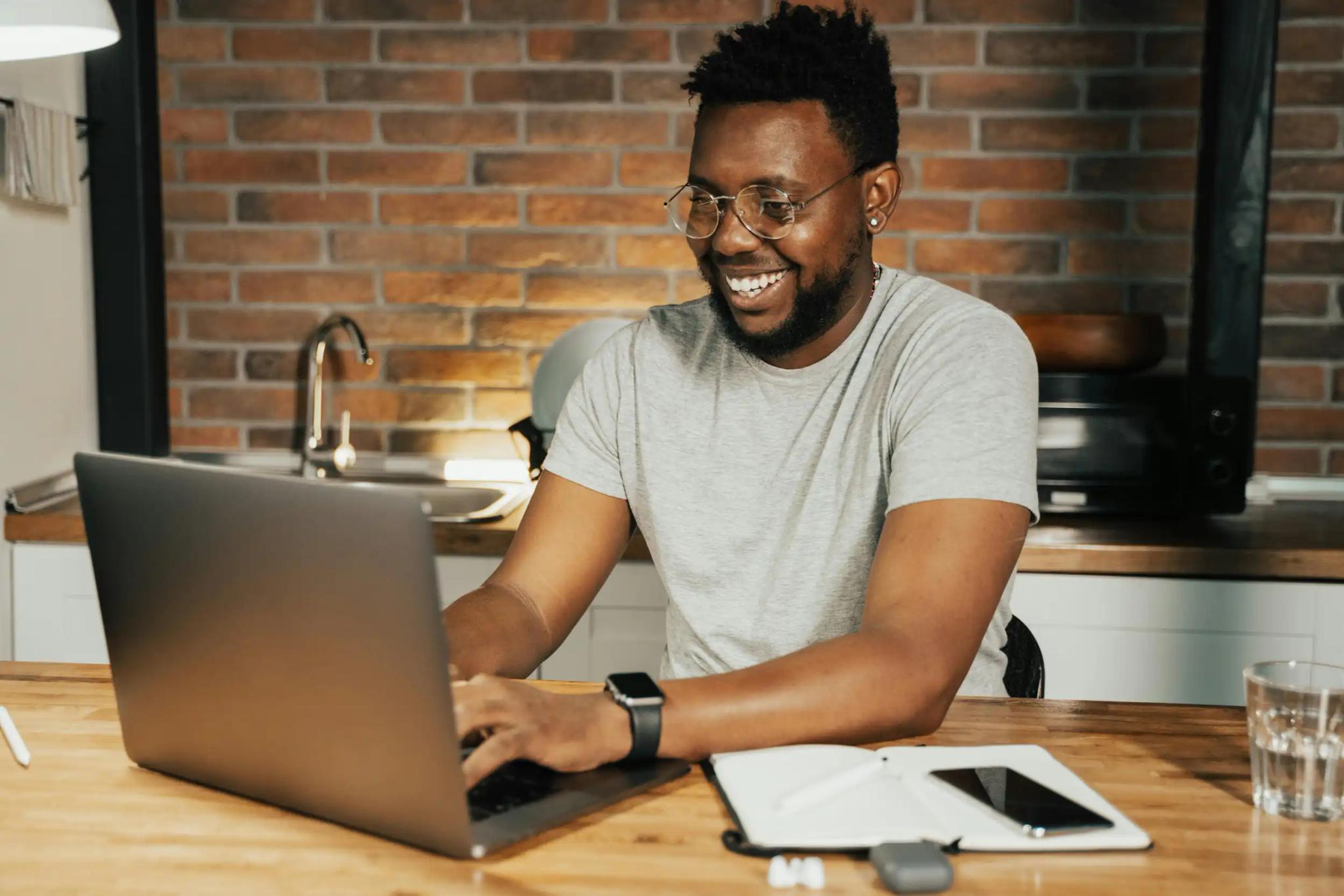 Man using laptop in modern kitchen