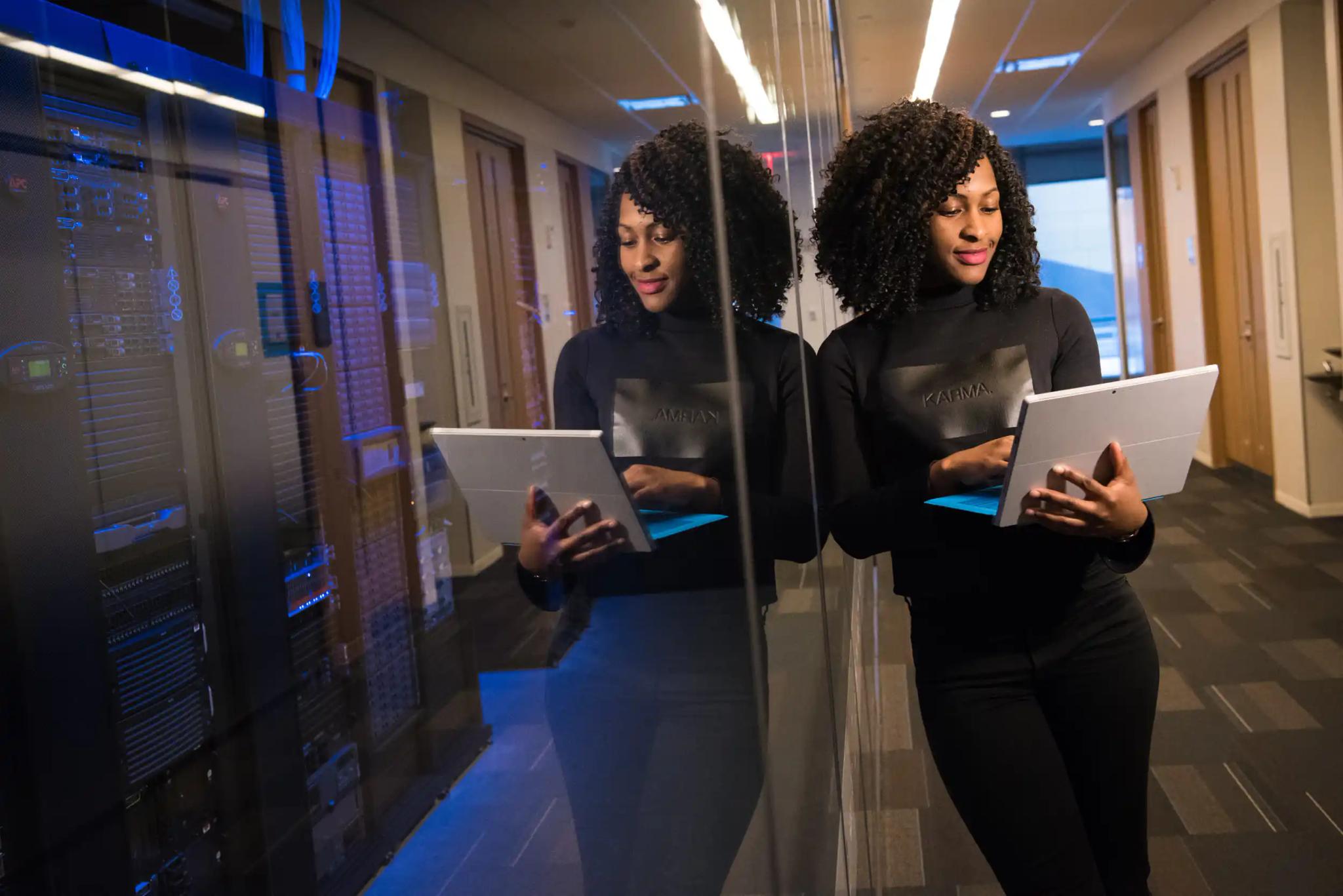 Woman using a tablet in a server room