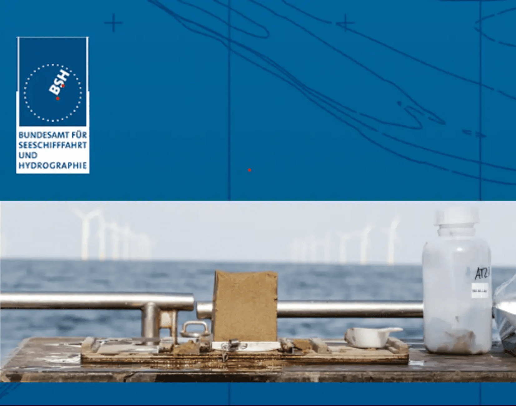 Table with sample containers in front of offshore wind turbines and BSH logo