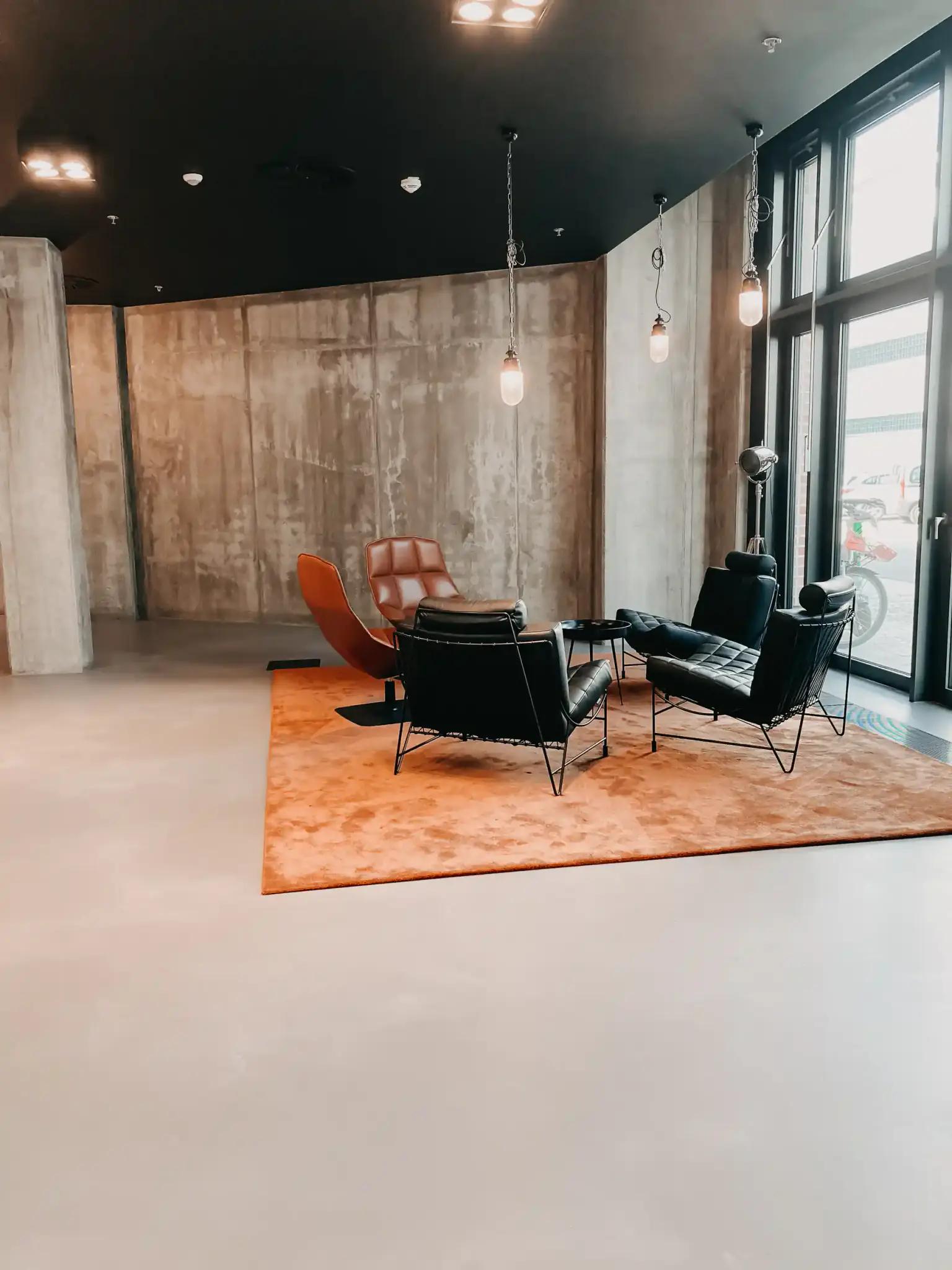 Modern waiting area with chairs and rug.
