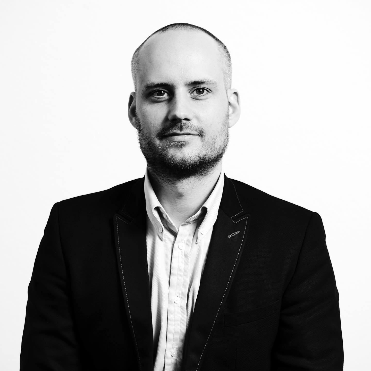 Portrait of a man in suit in black and white photo.