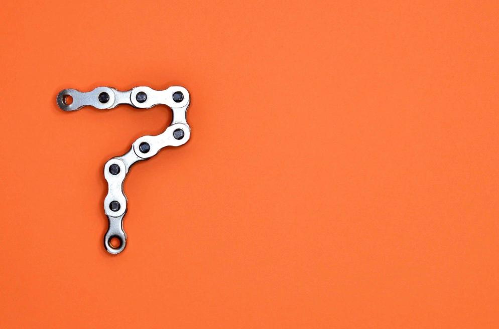 Bicycle chain shaped like a number on orange background
