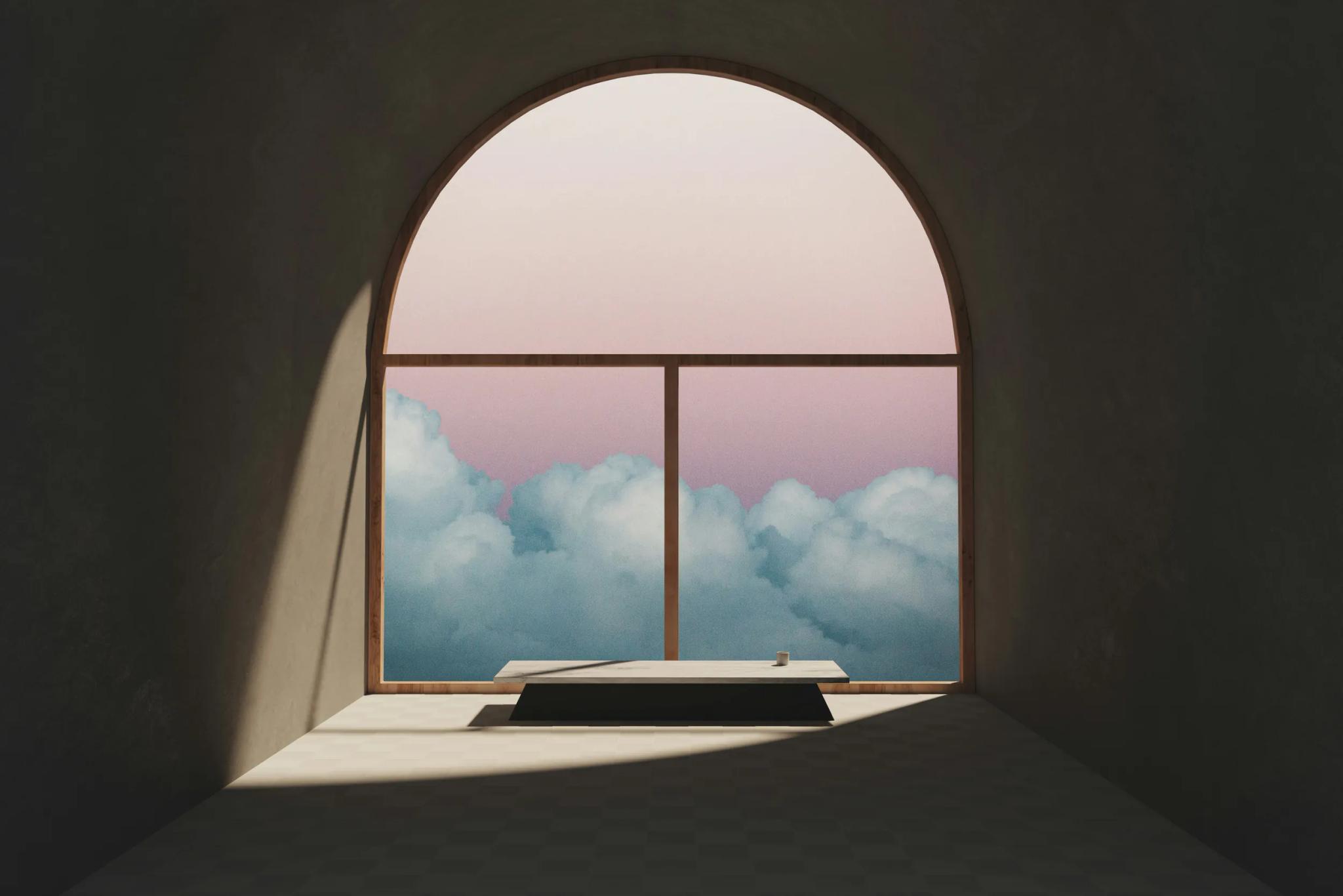 Arched window with view of clouds and sunset sky.