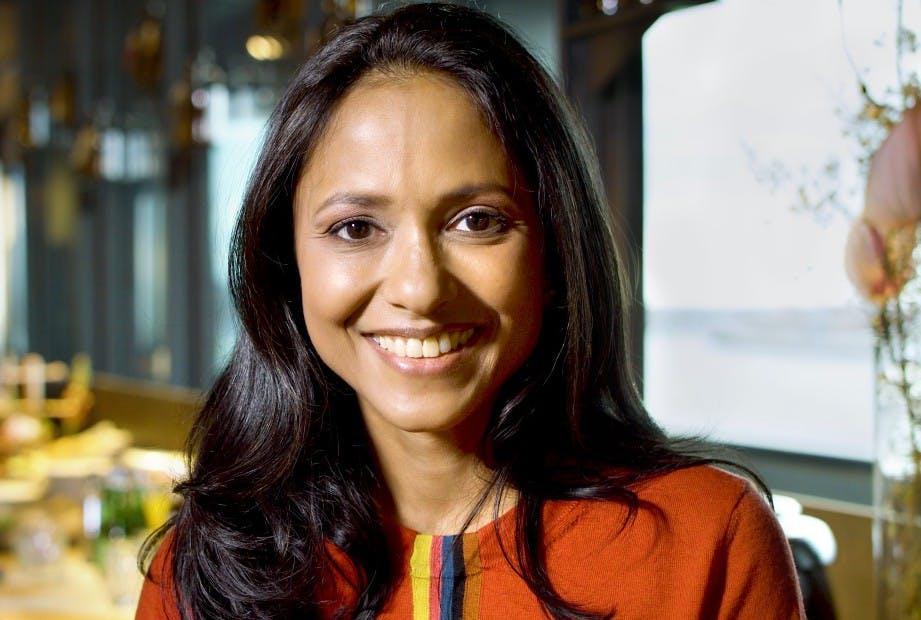 Portrait of a smiling woman with long dark hair.