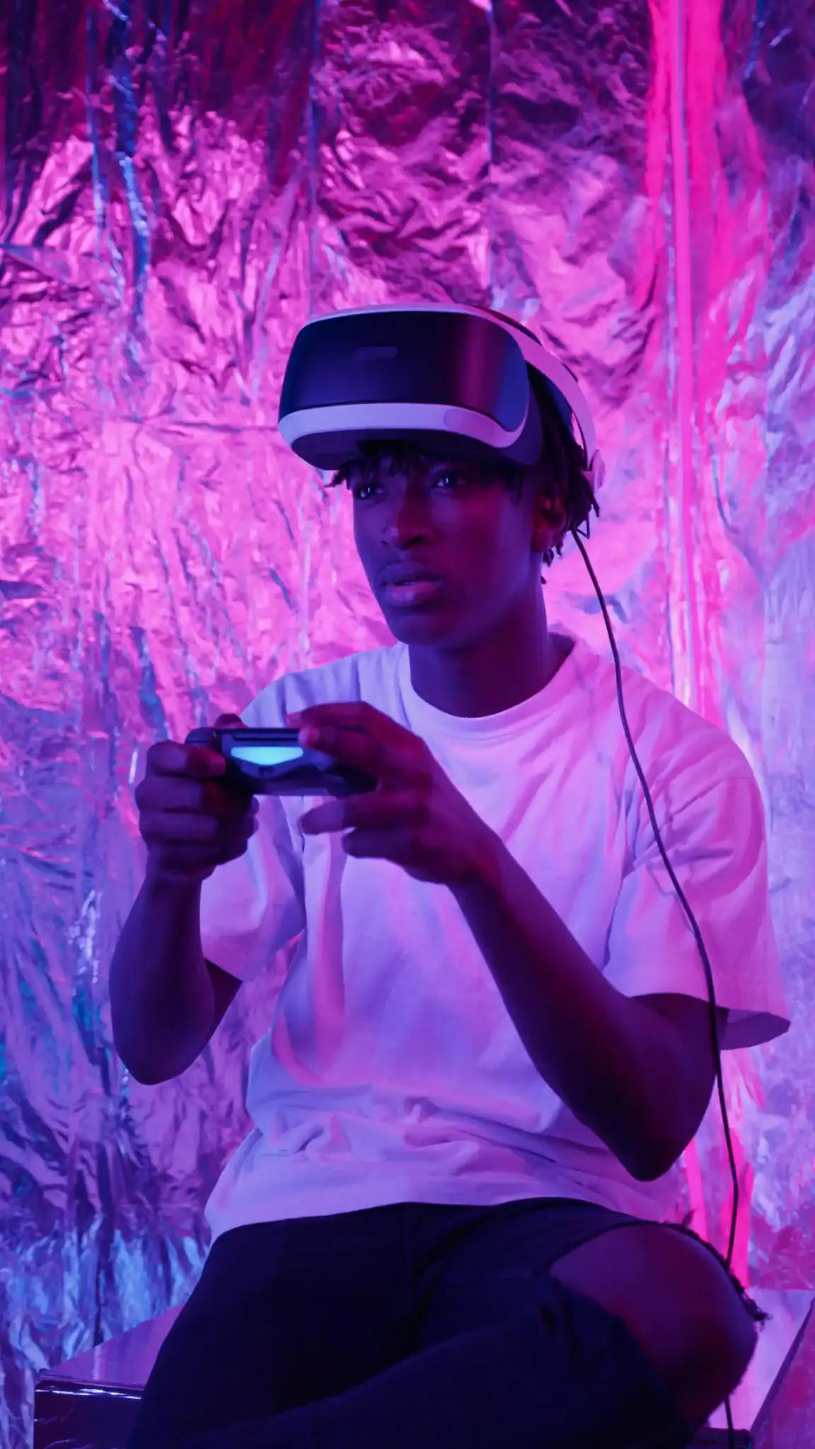 Young man with virtual reality headset and game controller.
