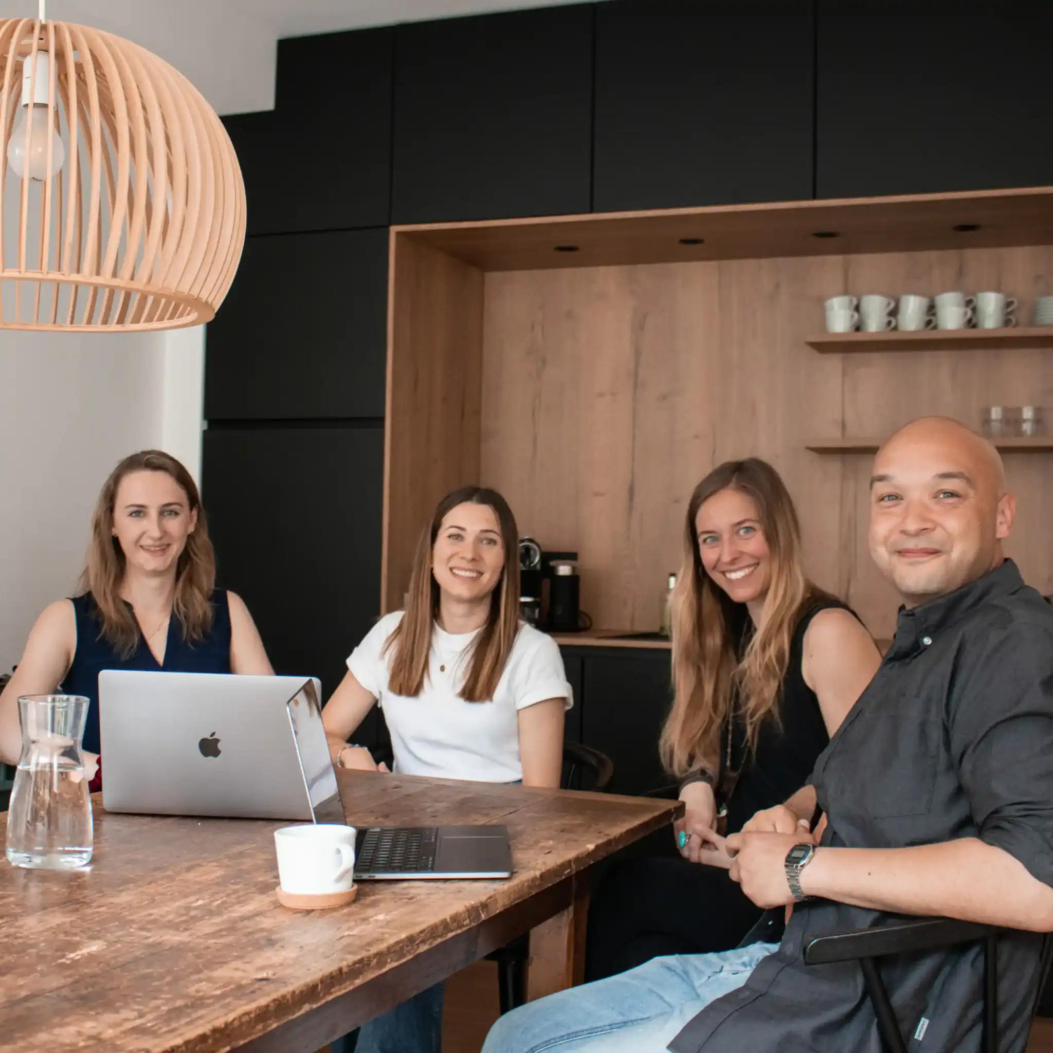 Group of four people at a meeting in a modern office