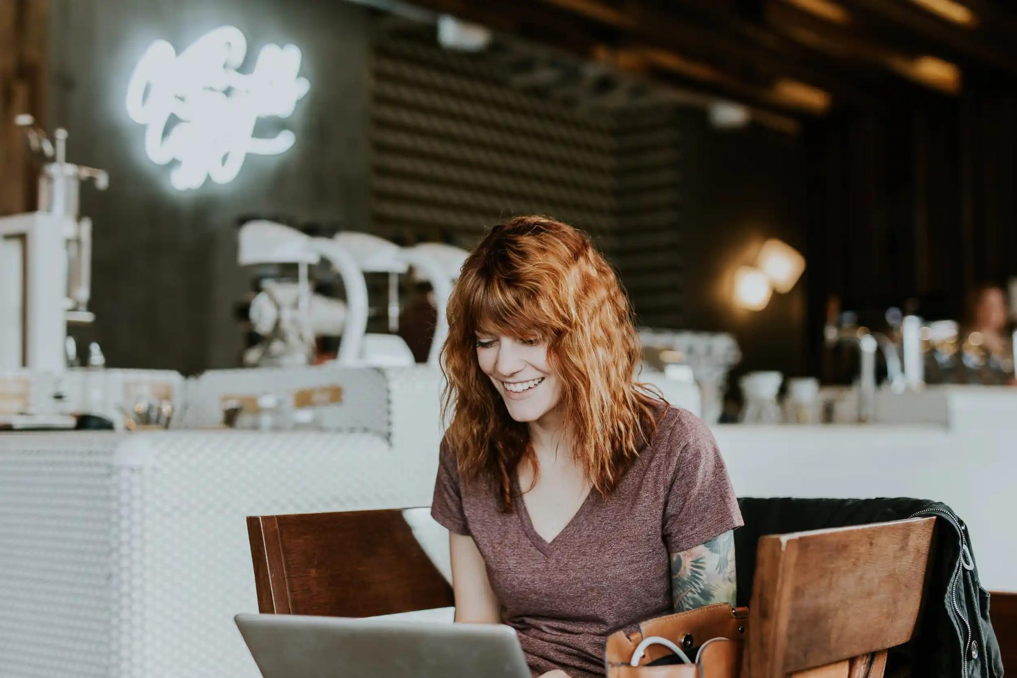 Woman working on laptop in café