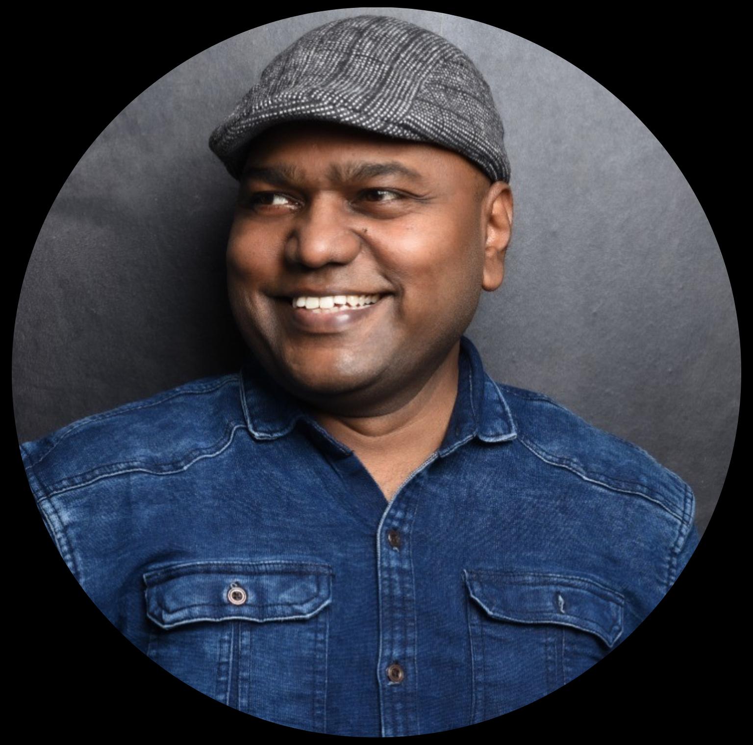 Black and white portrait of a man wearing a flat cap.