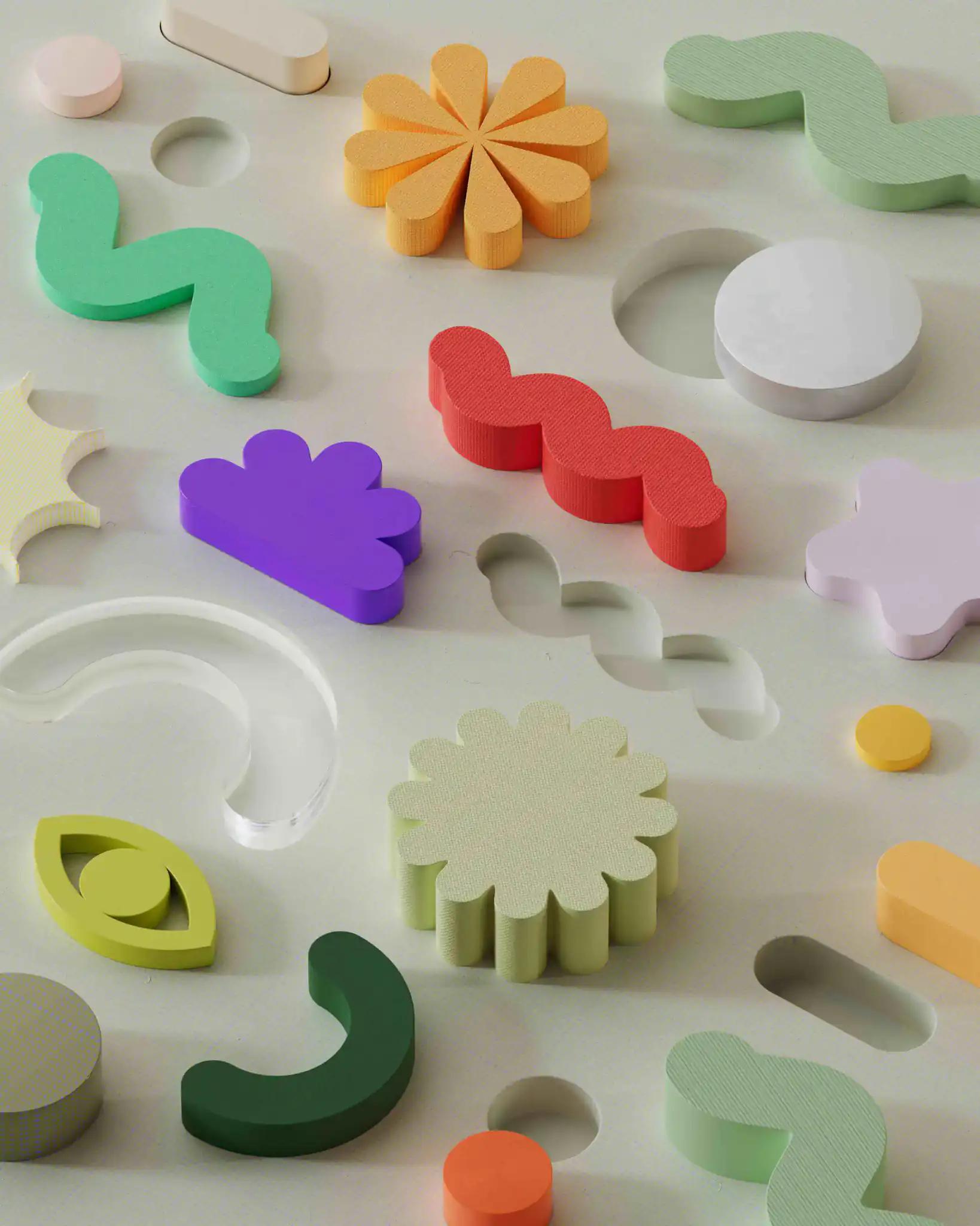 Colorful abstract wooden shapes on light background.